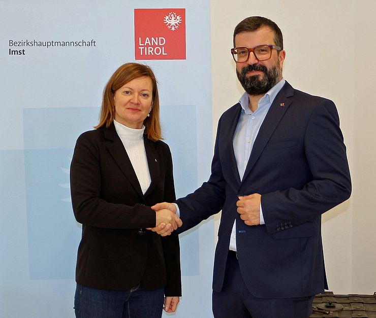 Bezirkshauptfrau Eva Loidhold und Bürgermeister Daniel Raffl schütteln sich die Hände.. 