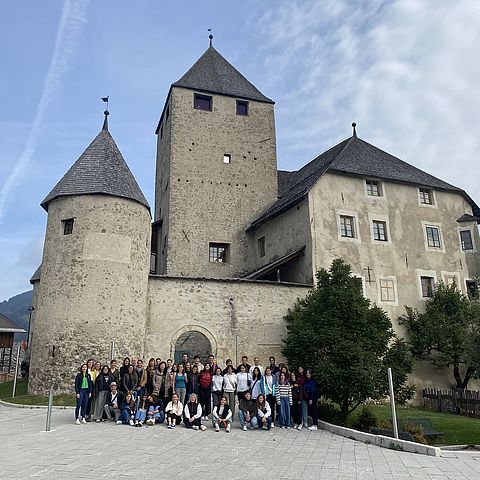 Gruppe von Jugendlichen posiert vor Burg/Schloss