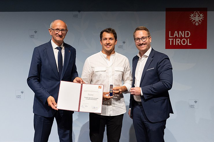 Verleihung Tiroler Sportehrennadel in Gold mit Brillant, v.l.n.r. LH Anton Mattle, Samuel Maier, 1. LHStv. Philip Wohlgemuth