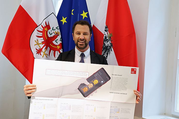 LHStv Georg Dornauer mit einem Exemplar des Tiroler Integrationskalenders 2024 in seiner Hand