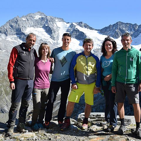 Die Geschäftsführerinnen und Geschäftsführer der Tiroler Naturparke posieren zusammen mit Bergen im Hintergrund.