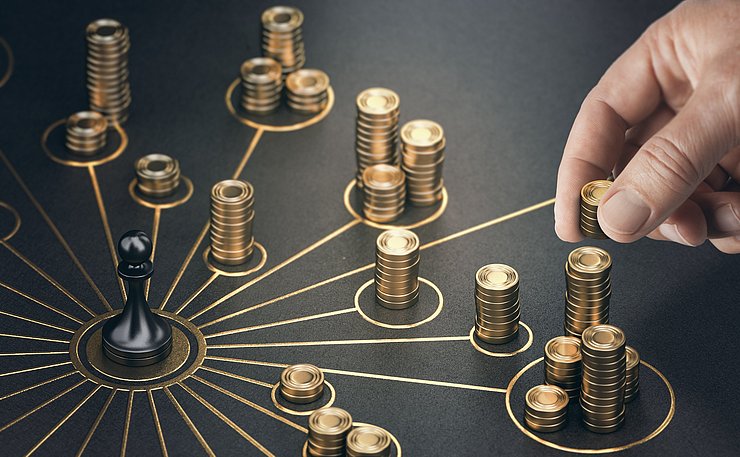 © 2216604693 Man,Puting,Golden,Coins,On,A,Board,Representing,Multiple,Streams