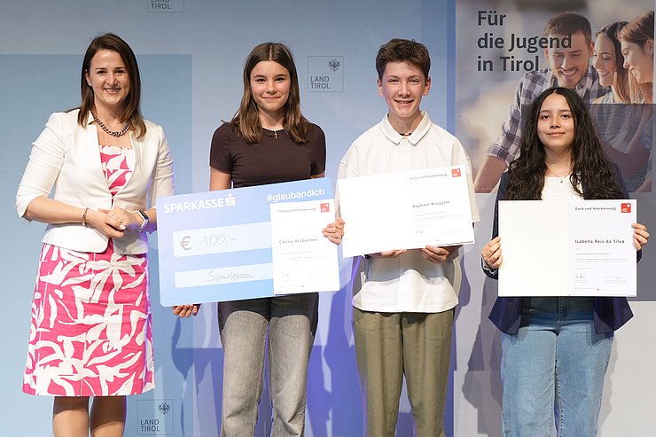 © Land Tirol/Trenker Jugendliche mit Urkunden und eine Frau auf der Bühne