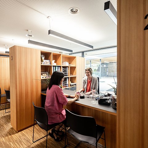 Mitarbeiterin unterhaltet sich mit Bürgerin