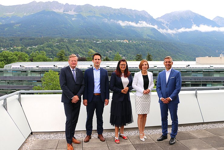 Gruppenfoto auf Terrasse des MCI, im Hintergrund die Nordkette