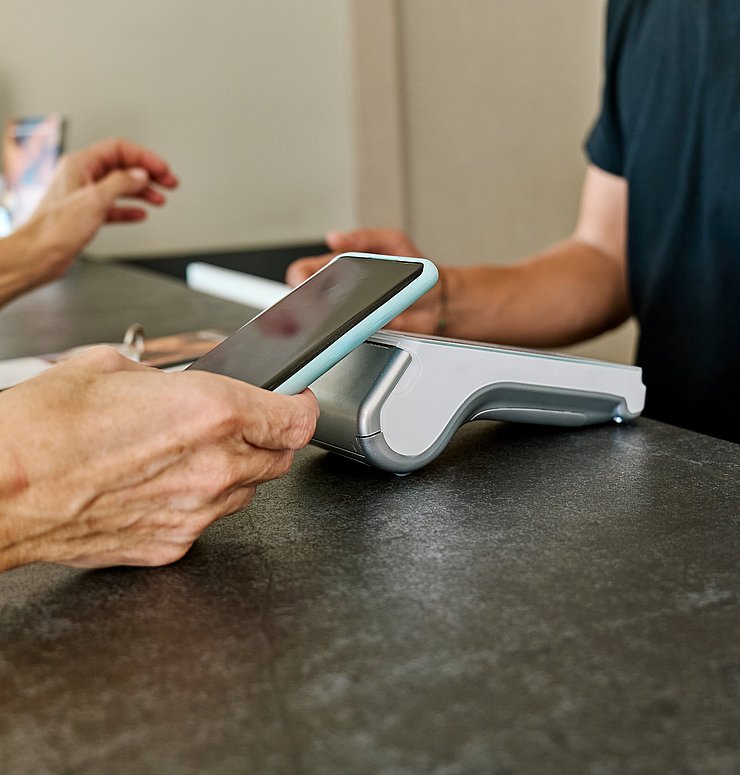 Unrecognizable,Woman,Paying,With,Mobile,Phone,By,Card,Reader