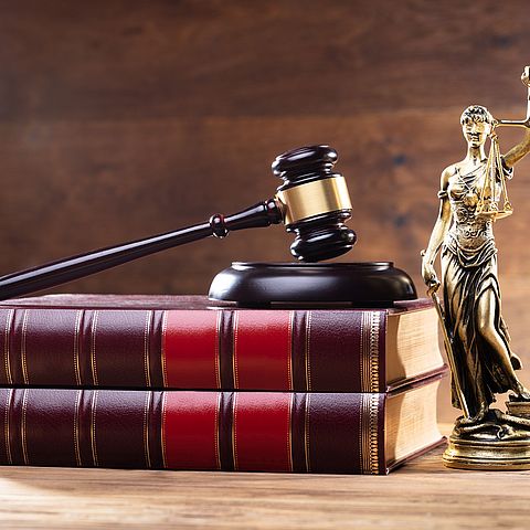 Close-up,Of,Golden,Lady,Justice,Near,Wooden,Gavel,Over,Law