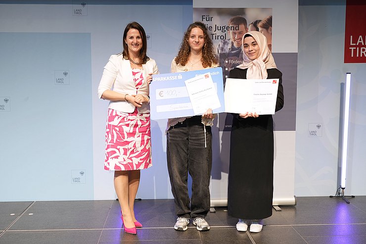 © Land Tirol/Trenker Jugendliche mit Urkunden und eine Frau auf der Bühne