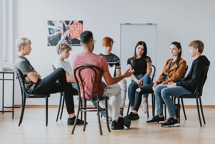 Group,Of,Teenagers,Discussing,In,A,Circle,On,A,Group