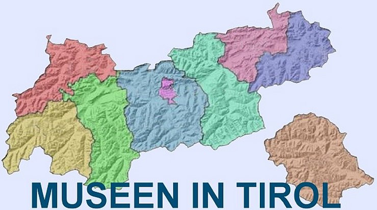 Foto der Landkarte Tirol, farbig in die Bezirke unterteilt.