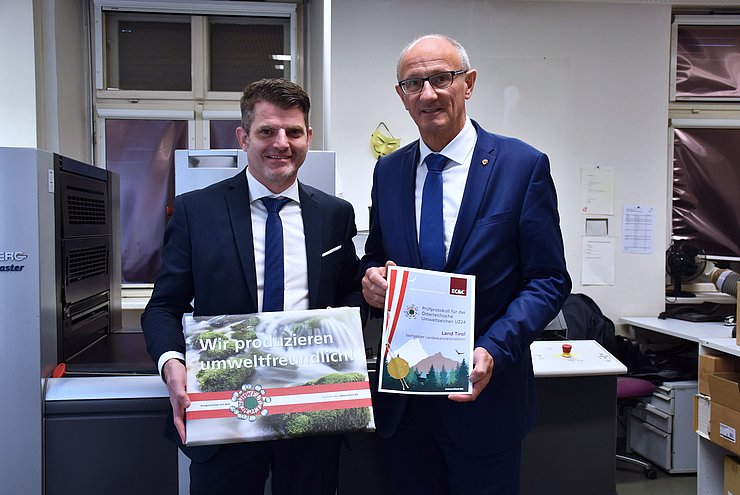 Landeshauptmann Anton Mattle und Leiter der Landeskanzleidirektion Florian Schöpf präsentieren die Urkunde.