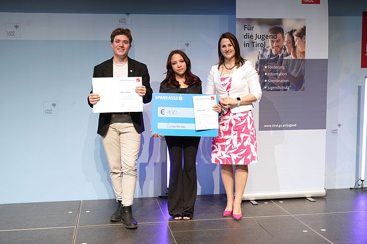 © Land Tirol/Trenker Jugendliche mit Urkunden und eine Frau auf der Bühne
